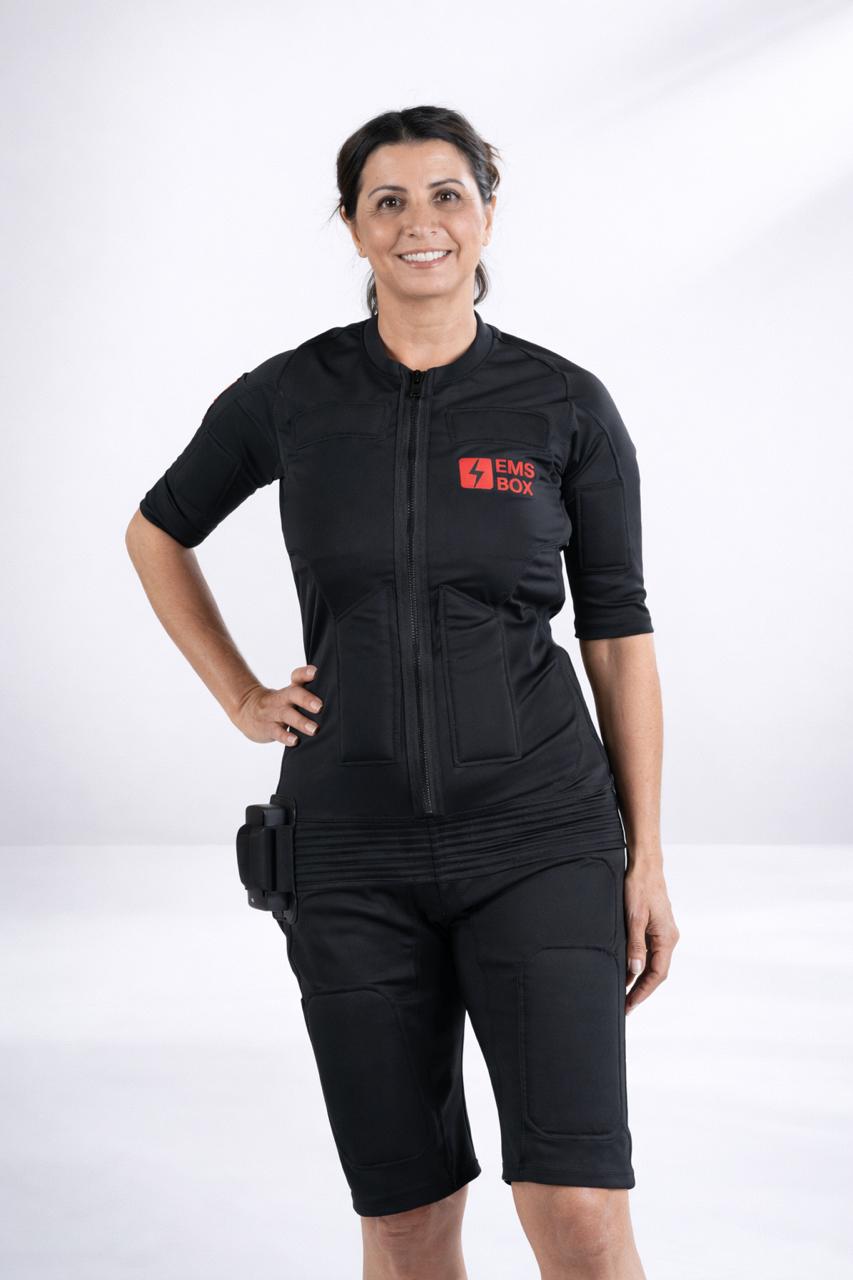 Woman wearing EMS Box Magic Suit with device attached